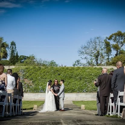 Wedding couple and guests beside a lake