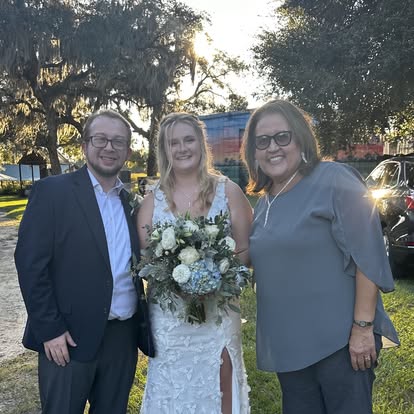 Esther and a couple celebrating outdoors