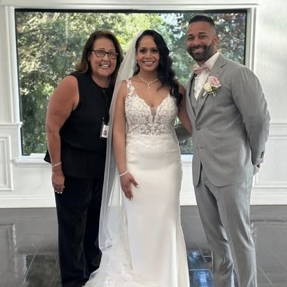 Esther with newlyweds outside a white building