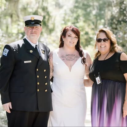 Esther with a bride and groom in military dress