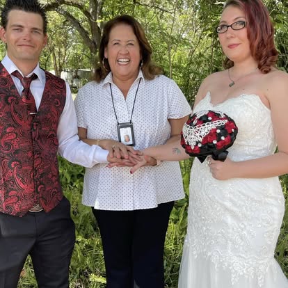 Esther with a couple holding a wedding bouquet