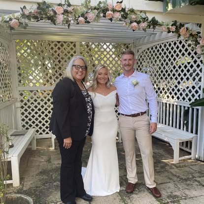 Esther with a couple beside a decorated gazebo