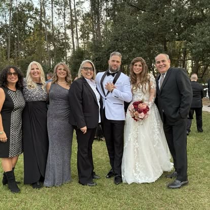 Wedding party gathered in a woodland setting