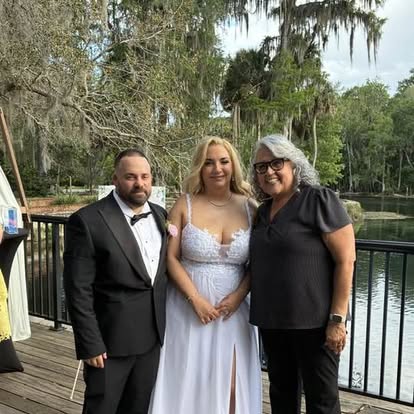 Esther with a couple beside a waterfront railing