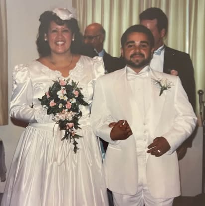Esther and her husband on their own wedding day