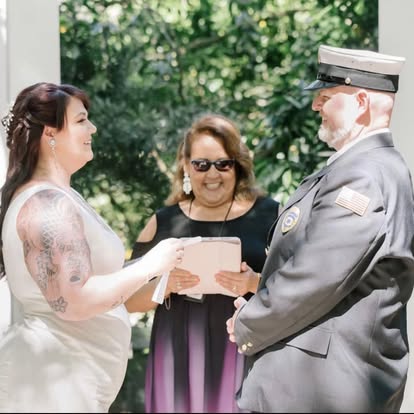 Esther smiling as a couple exchange their vows outdoors